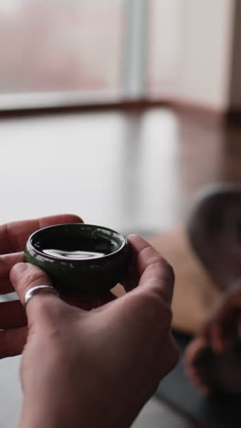 a small cup of tea in hands