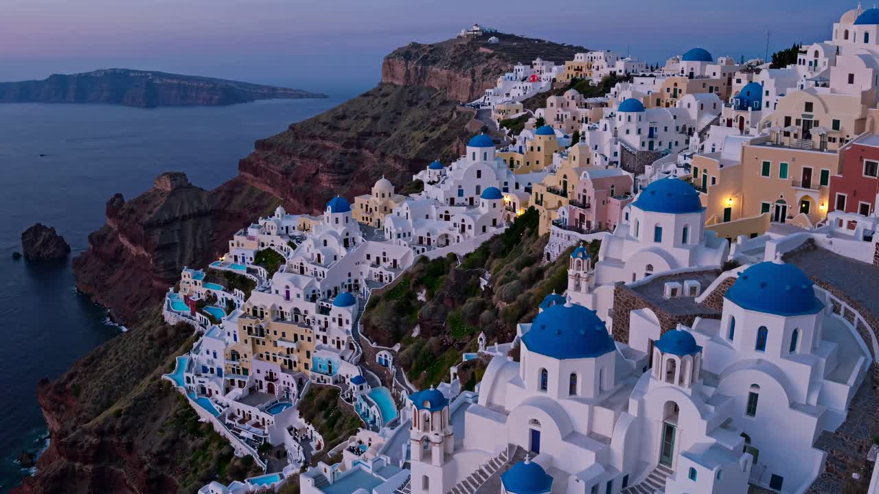 Aerial video capturing the serene beauty of Santorini's iconic white and blue architecture