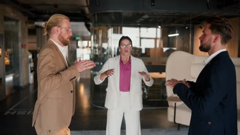 breathing techniques in a team of office workers. a girl in a white suit and a pink shirt, a guy in a brown jacket and a guy in a blue jacket doing breathing techniques on a mat in a modern office