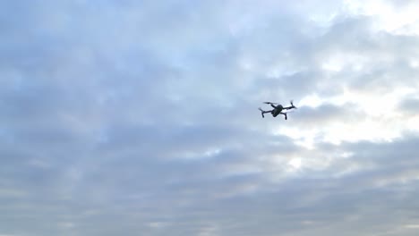 drone in flight against cloudy sky at sunset