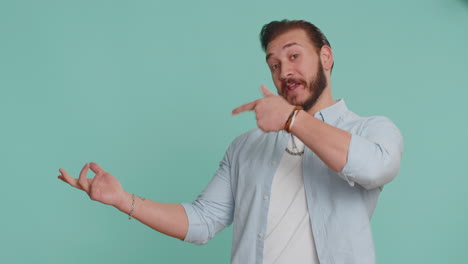 Lebanese-man-showing-thumbs-up-pointing-empty-place-advertising-area-for-commercial-text,-copy-space