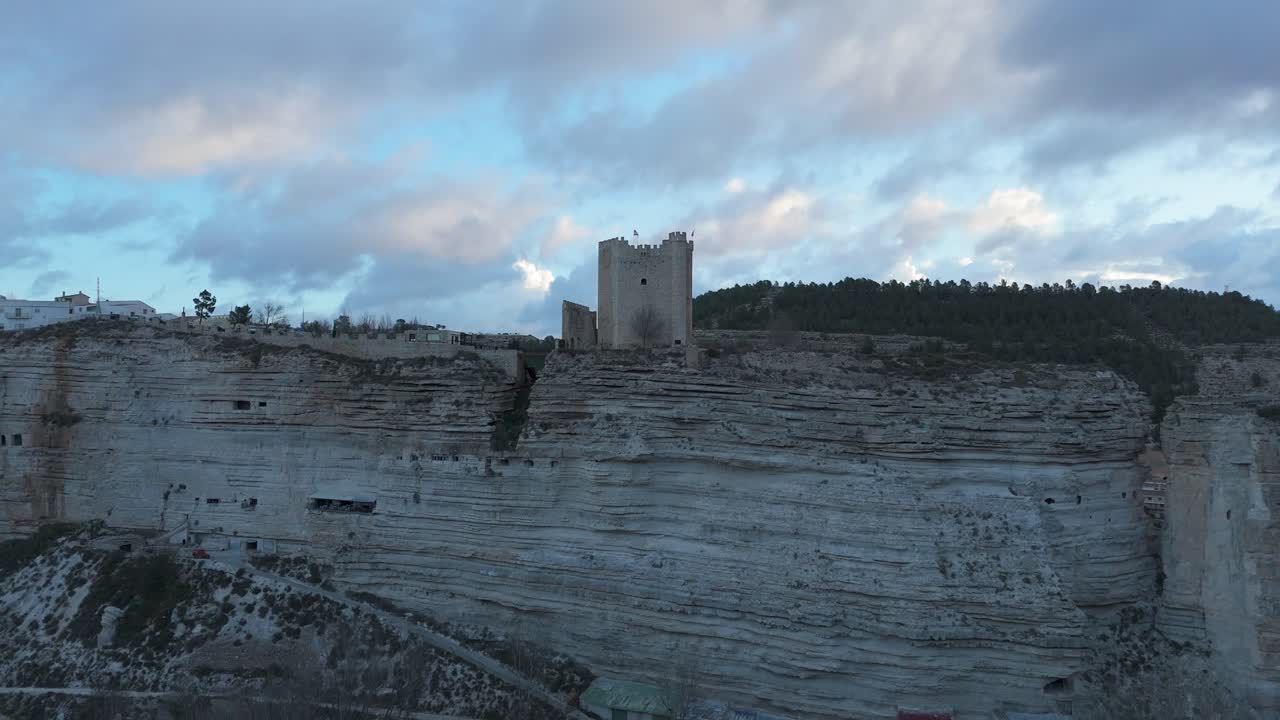 Ascending drone movement the castle of the medieval village of Alcal&aacute; del Jucar, Spain, one of the most beautiful villages in Spain