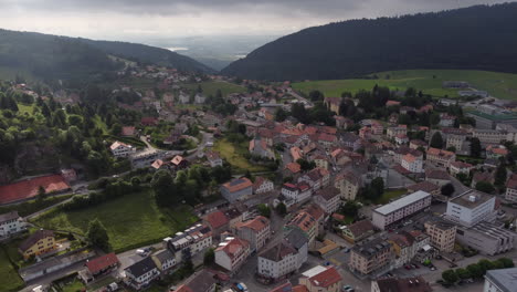 Rotating-aerial-shot-high-above-buildings-in-Sainte-Croix,-Switzerland