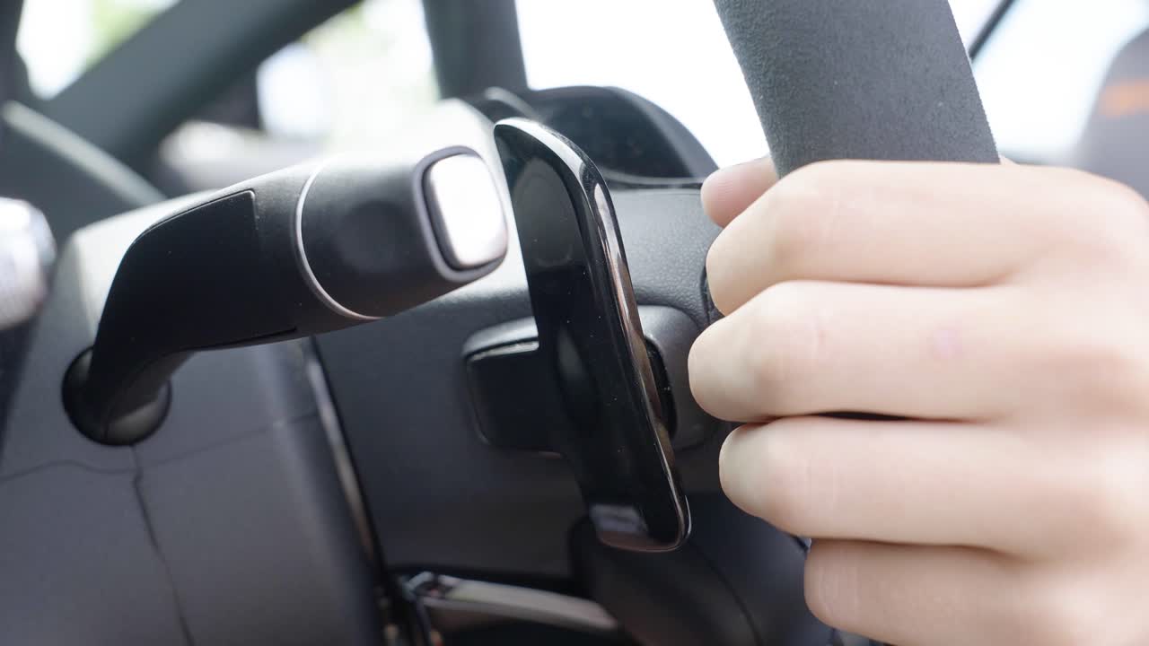 Close-Up of Hand Using Paddle Shifter Inside a Luxury Sports Car