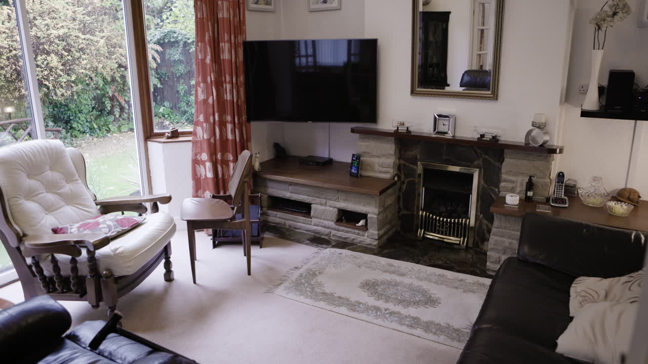 Living room interior with armchair, fireplace, and TV