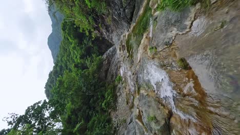 aerial vertical flight over rio bani river in wilderness near waterfall las yayitas on dominican republic