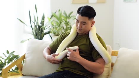 man holding snake indoors