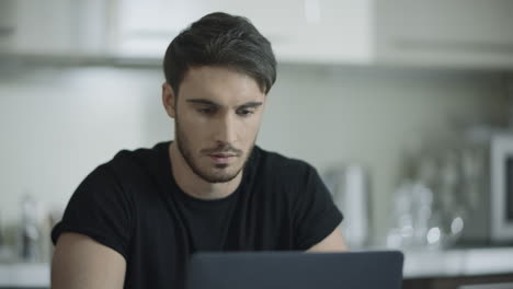 Business-man-face-working-laptop-computer-at-home.-Businessman-using-computer