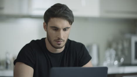 business man face working laptop computer at home. businessman using computer