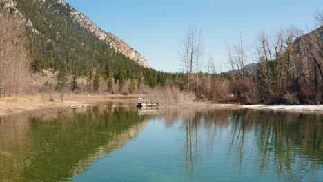 aerial orbit of small run down footbridge on a beautiful lake