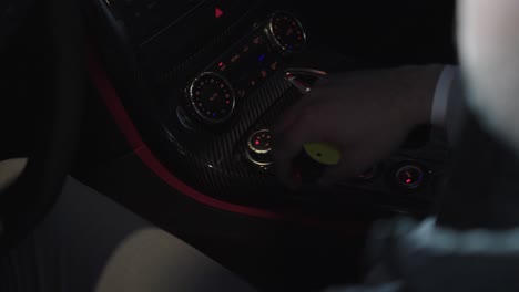 driver in suit touching the buttons in the vehicle