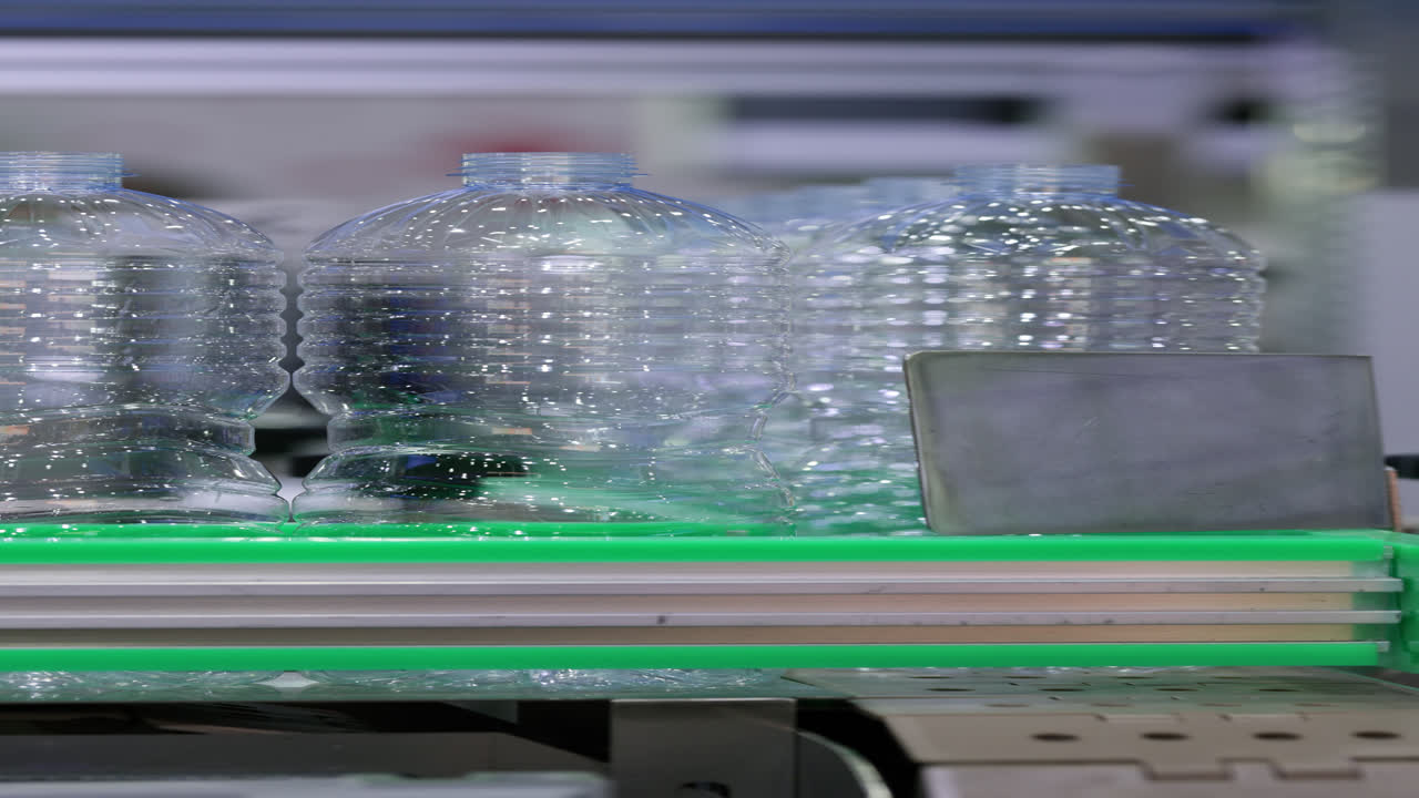 Empty Plastic Bottles Moving on an Automated Production Line