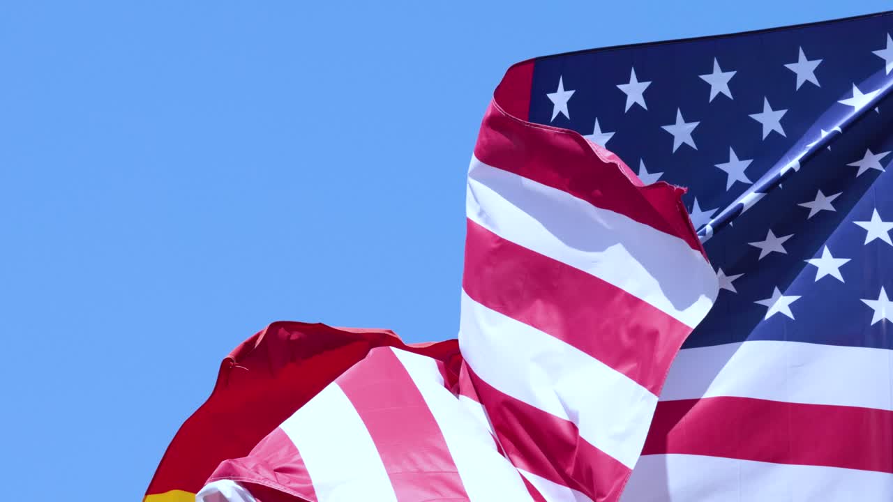 American and Spanish flags waving in the wind