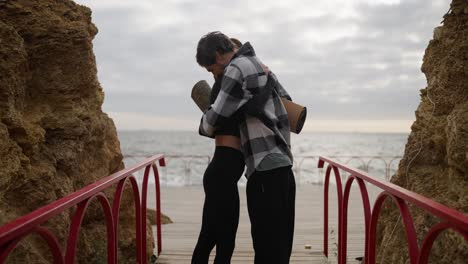 couple hugging at the beach after yoga