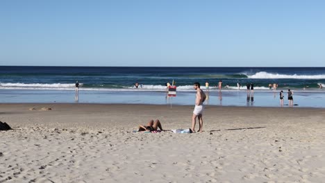 people playing volleyball on a sunny beach