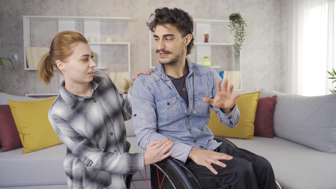 Happy disabled man and his girlfriend having fun at home.
