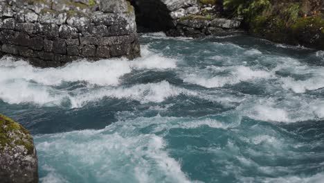 graceful chaos: slow-motion capture of crashing, whirling water attacking the stone bridge