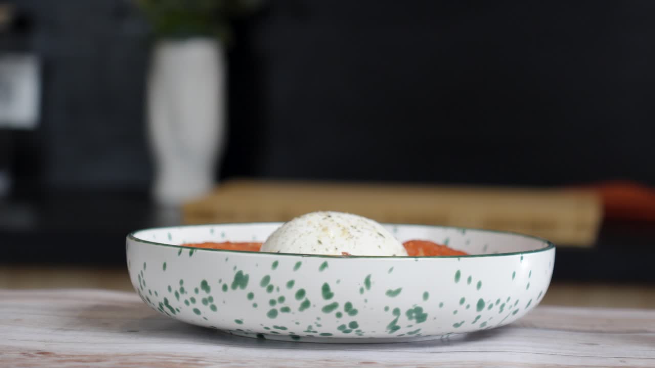 revealing shot of Buratta prepared in a disk ready to be cooked in a restaurant