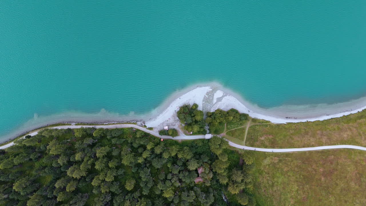 Aerial view of turquoise lake near Silvaplana and lush landscape