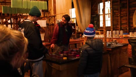 instructor teaching candle making to visitors