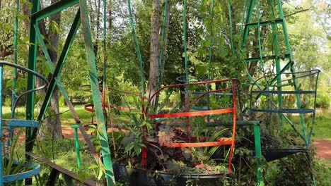 Tropical-Plants-Growing-While-Planted-Into-The-Old-Rusty-Metal-Swing