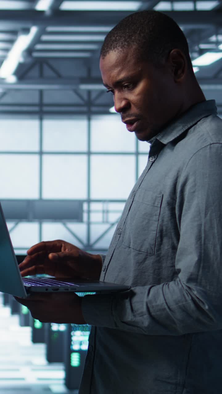 Vertical video Portrait of happy system administrators in data center using devices