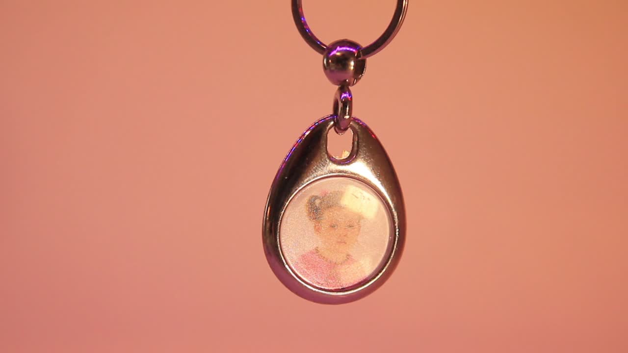 Close Up of the Hanging Child's Photo in Metal Souvenir Keychain