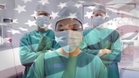 Animation-of-flag-of-usa-waving-over-surgeons-in-face-masks