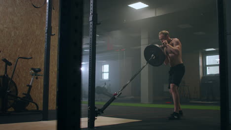 Man-doing-Single-arm-Landmine-Squat-to-Press-exercise.-Man-doing-barbell-exercise-in-the-gym.-Strong-man-does-landmine-exercises-workout-with-barbell.