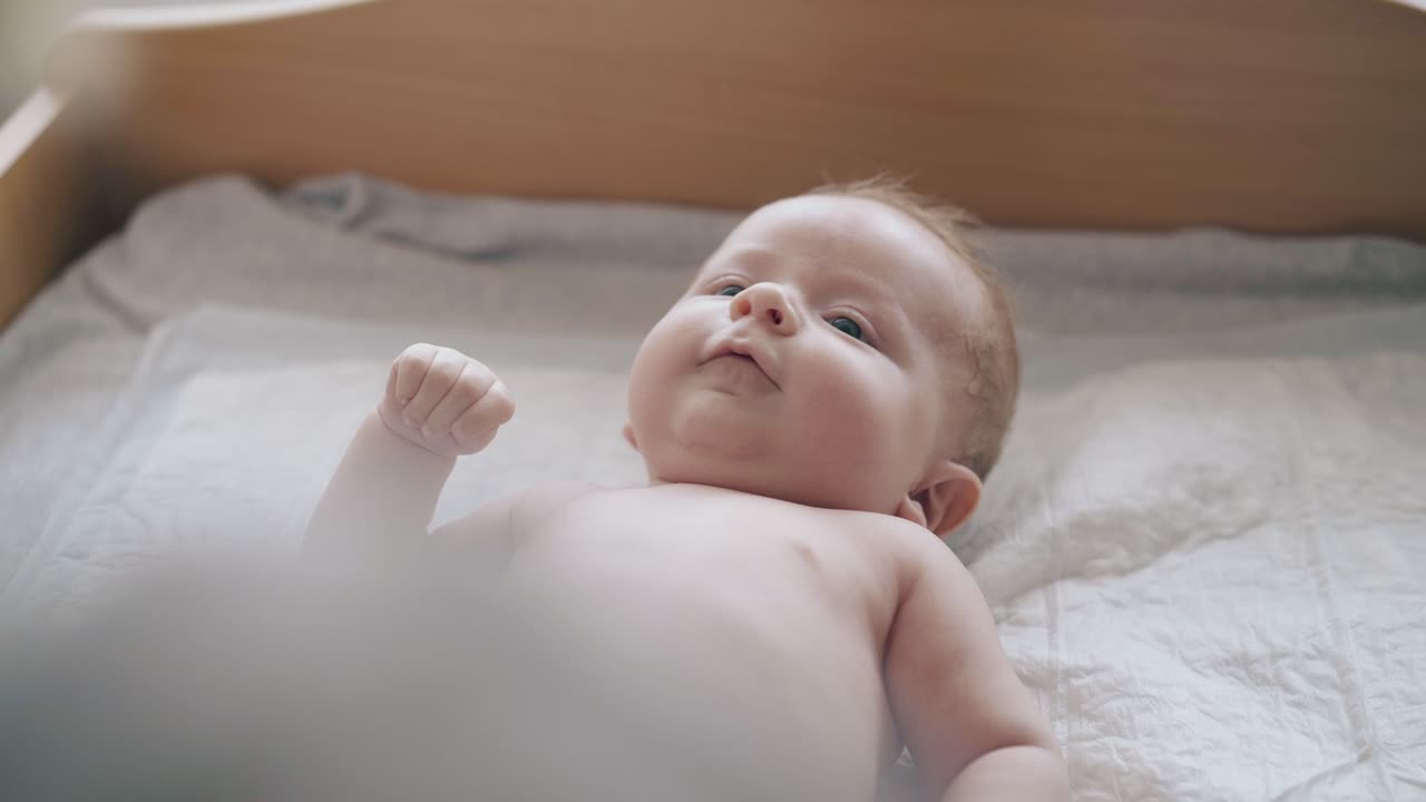 adorable newborn boy with blond hair and plump cheeks