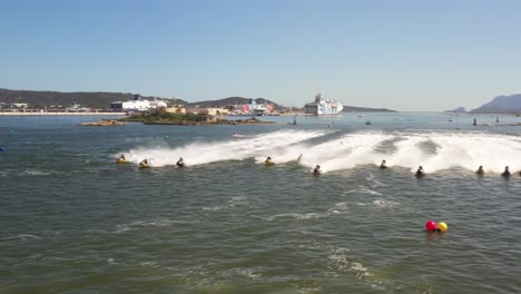 aerial footage of the jet ski races with the drone in front of the rushing water bikes