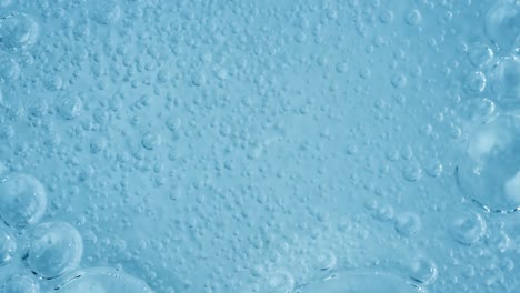 close-up view of bubbles in a light blue liquid