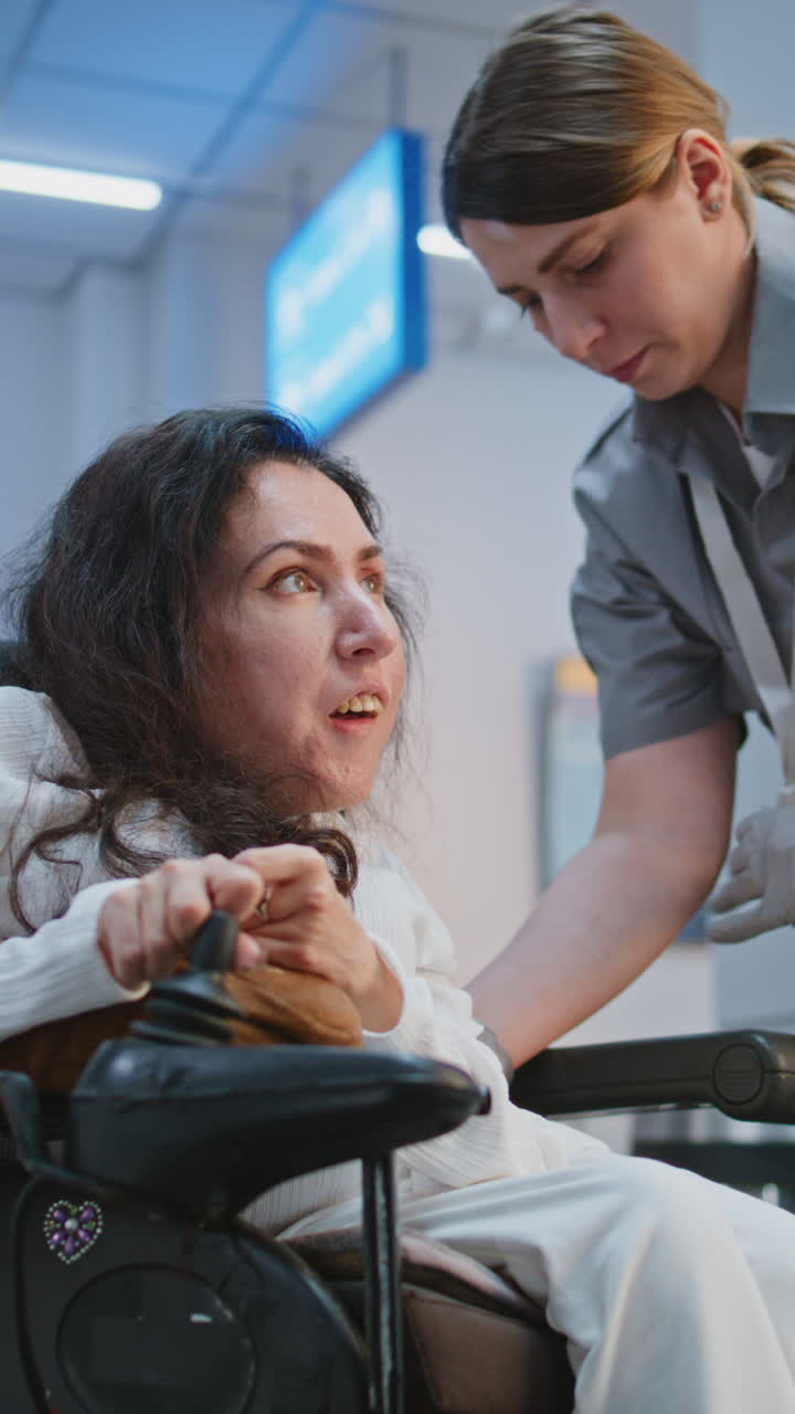 Woman in Wheelchair Receiving Assistance