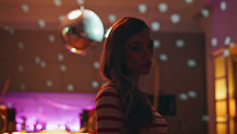 sad girl standing alone in party room after hangout close up. unhappy woman