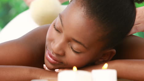 woman enjoying a herbal compress massage