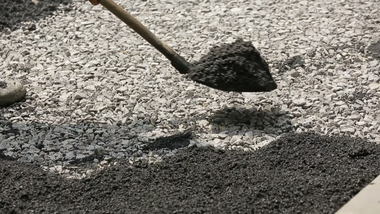 Team of workers making and constructing asphalt road construction