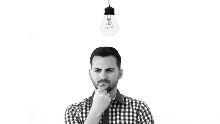 Young man lights up and he finds the solution to a problem