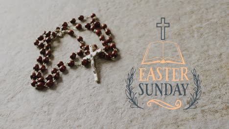 animation of easter sunday text over rosary on grey background