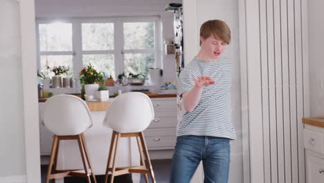 young downs syndrome man having fun dancing at home