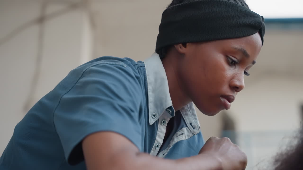 Young woman focused on carpentry, closeup workshop scene showing concentrated expression, steady hands working on wood surface, soft natural light, detailed grain and texture, cinematic shallow depth