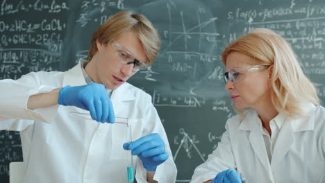 Scientists conducting a chemistry experiment in a classroom