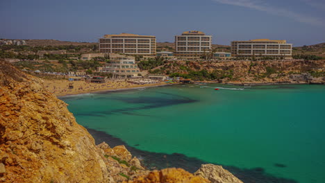 beautiful hotel buildings on coastline of malta island, time lapse view