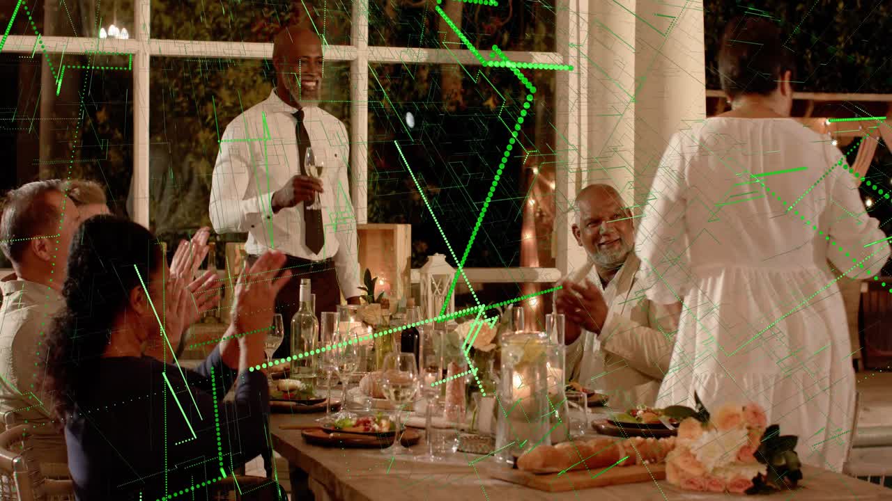 Male speaker raising glass, causing green overlays growing over table during event, guests clapping