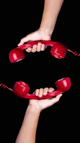 red vintage telephone handsets in vertical