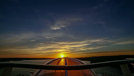 golden sunset shinning through the glass dome window on a ferry - hyper lapse from a boat an inlet of fjord