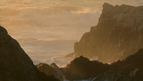 winter waves and surf pound the rocks of the big sur coast of california