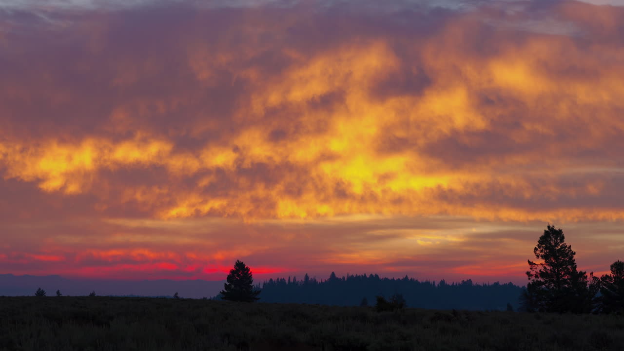 Vibrant Sunset Over Silhouetted Landscape