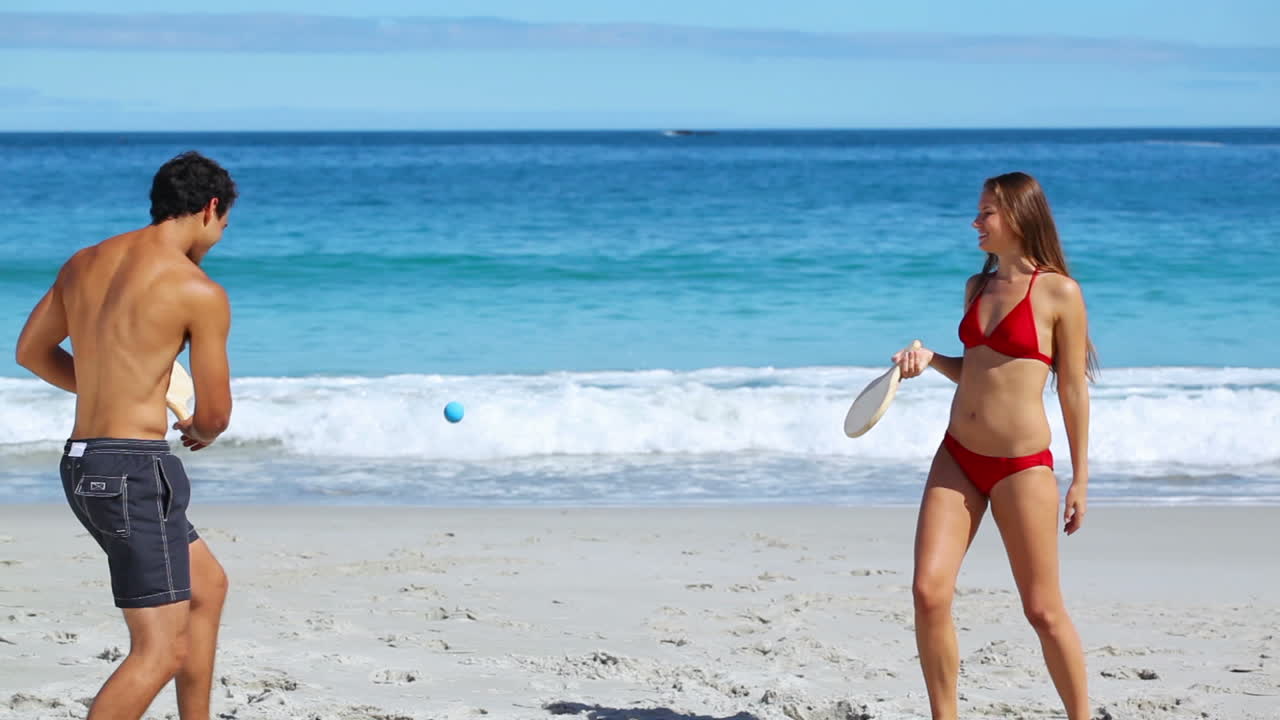 Playful couple playing with paddles