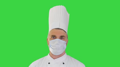 cocinero masculino usando una máscara médica de protección facial para la protección contra la enfermedad por virus en una pantalla verde, clave de croma