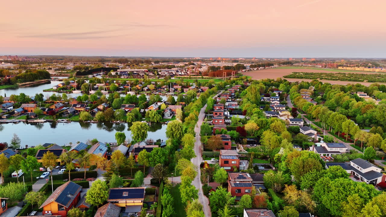 Amazing scenery of the picturesque village on the water with lush greenery. Flight over the Vinkeveen, the Netherlands at sunset.
